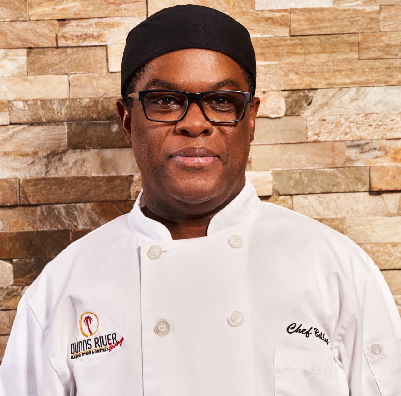 a man wearing a hat and glasses