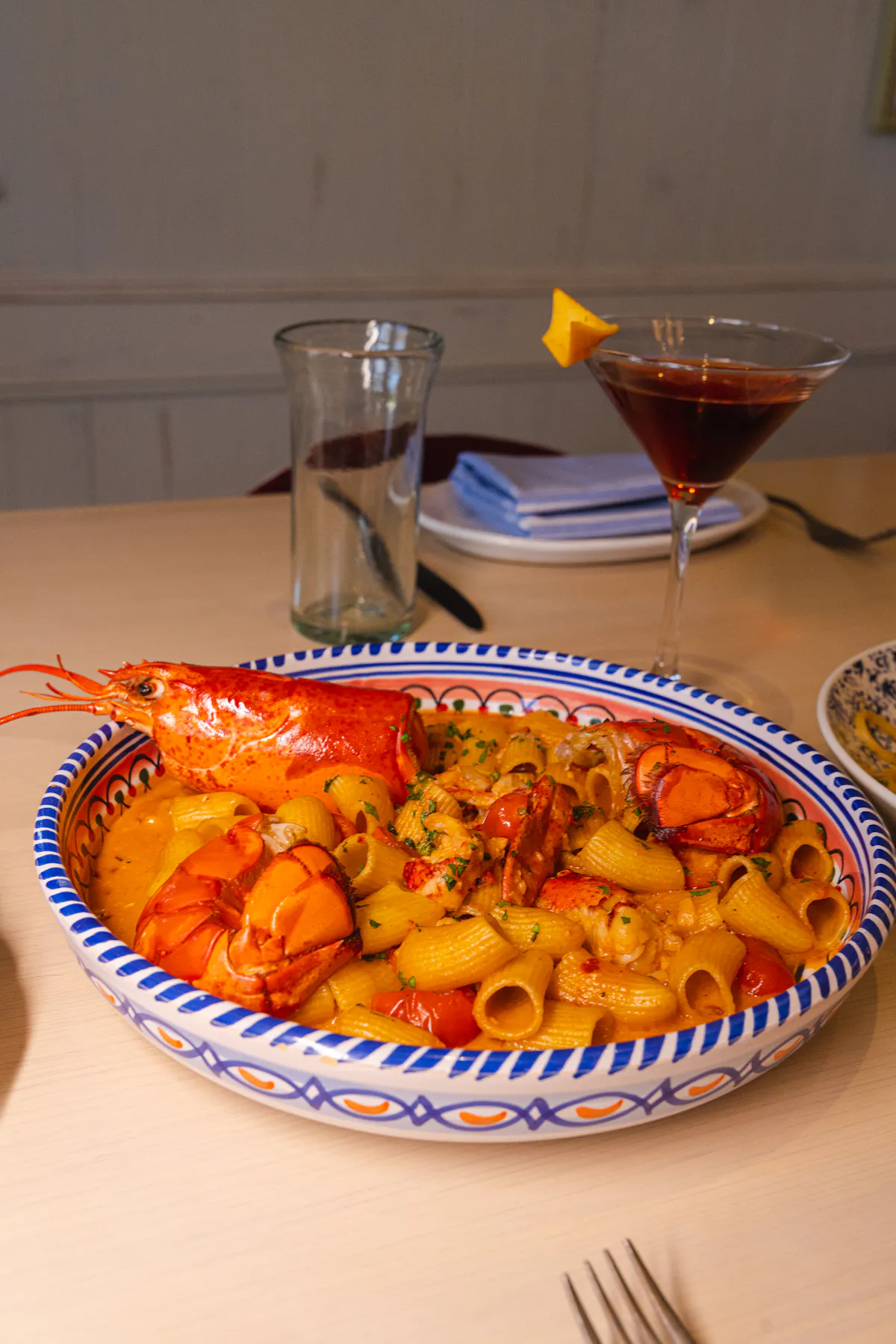 a bowl of pasta with lobster on it