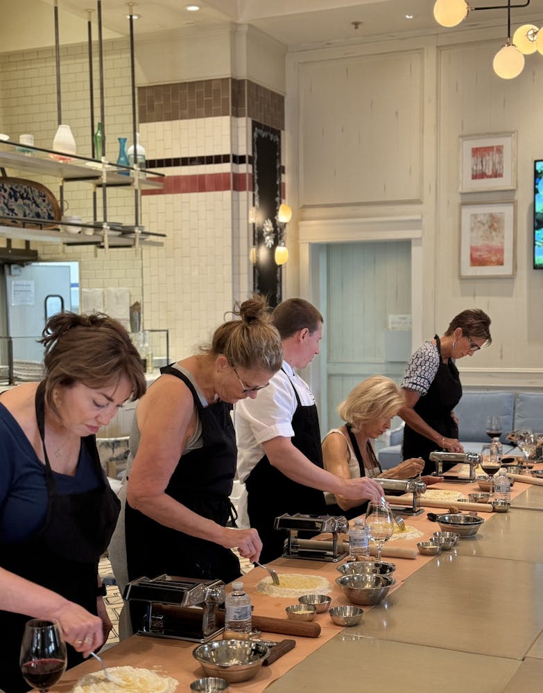 group pasta making class getting instructed by chef