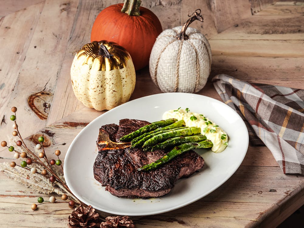 Thick slice of prime rib with rosemary au jus and creamy horseradish served on a wooden board at this italian restaurant in green valley ranch