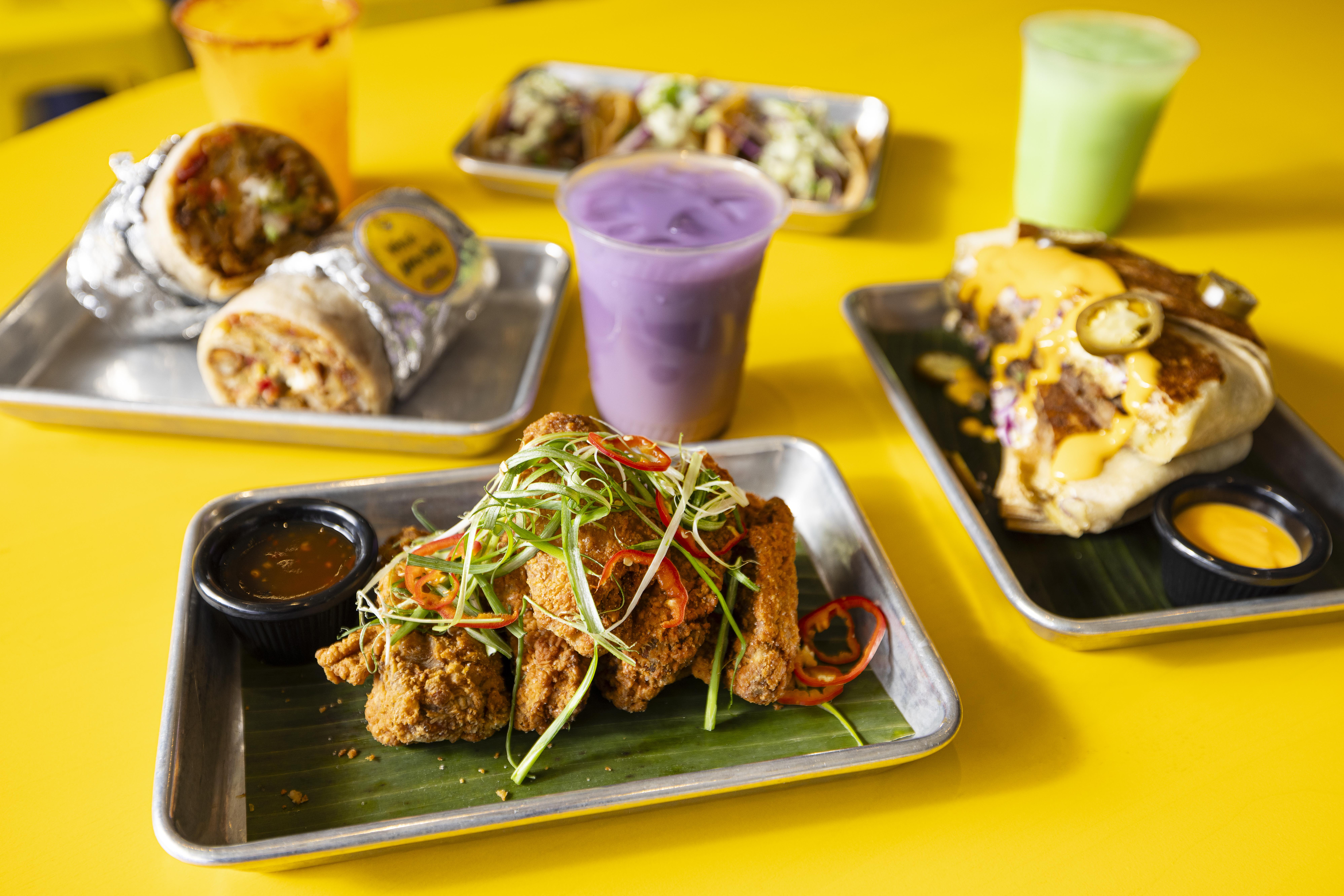 a trays of food on a yellow table