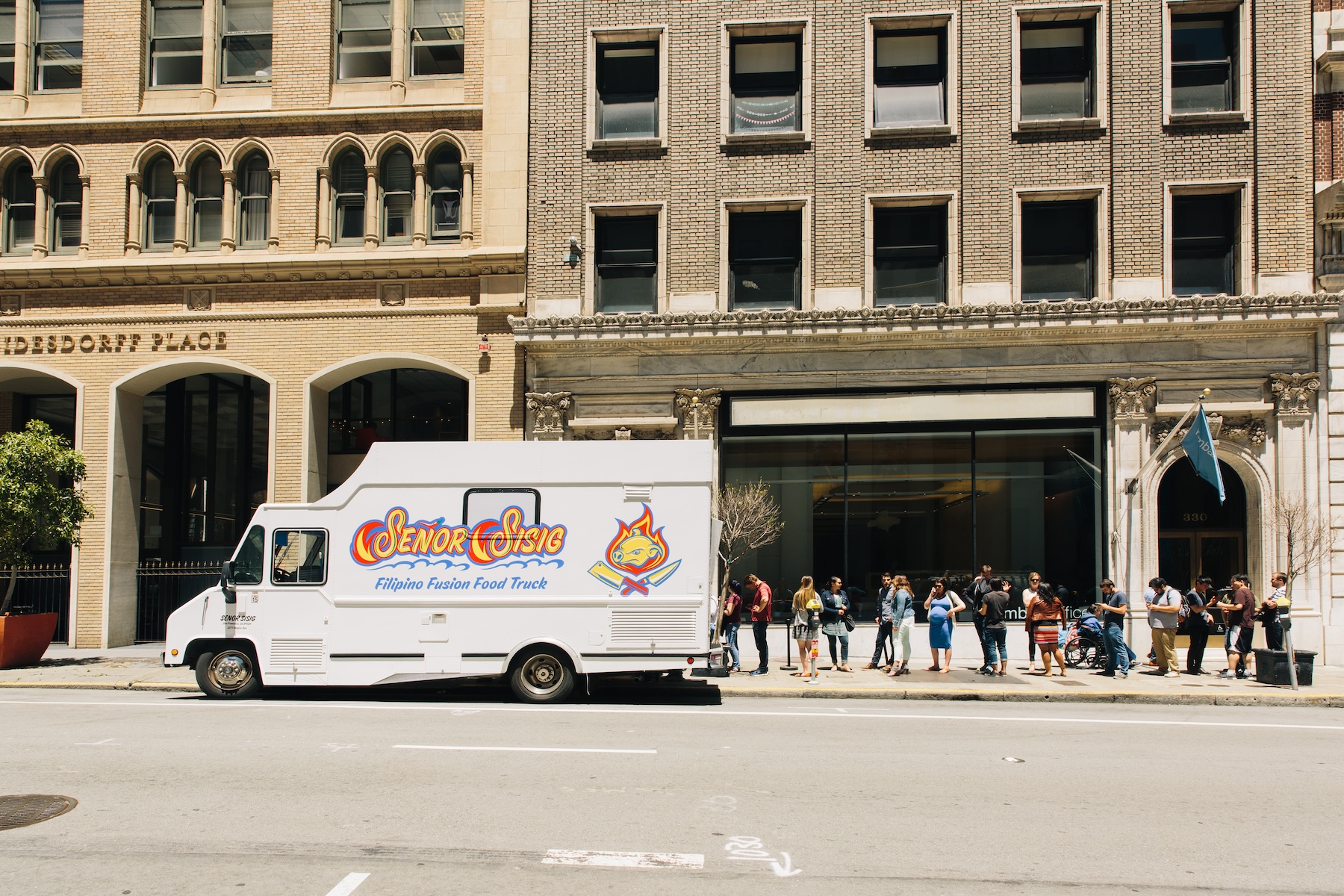 a group of people walking down the street in front of a building