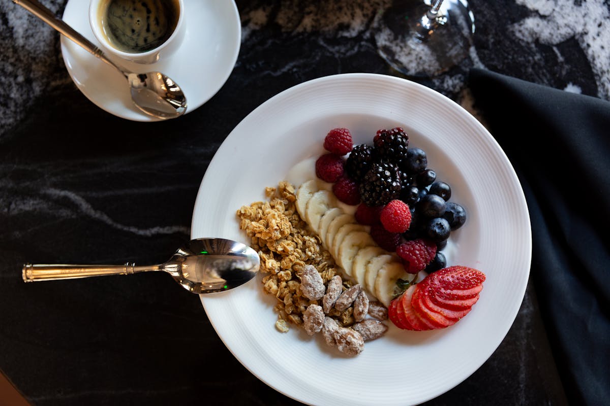 a plate of food with a slice of cake on a table