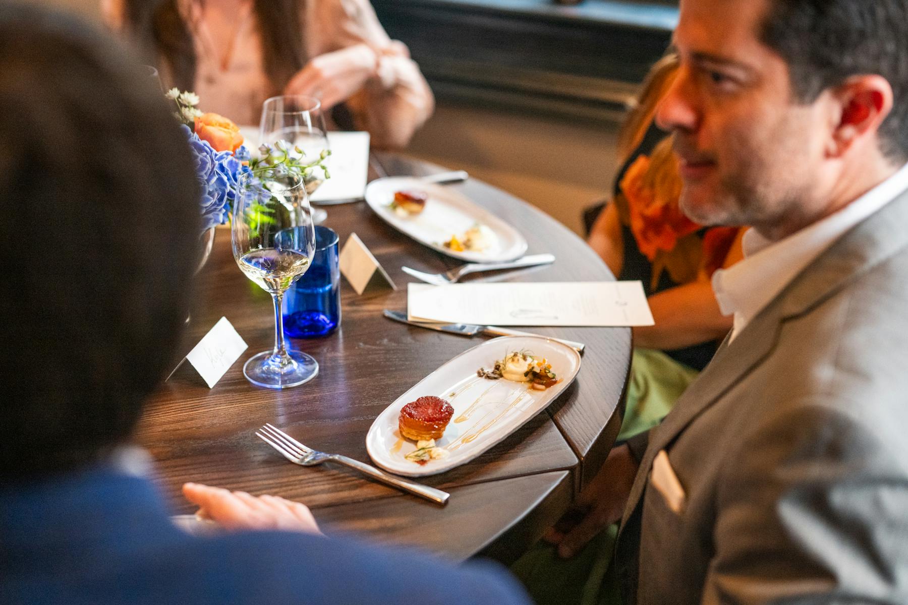 a group of people sitting at a table eating food