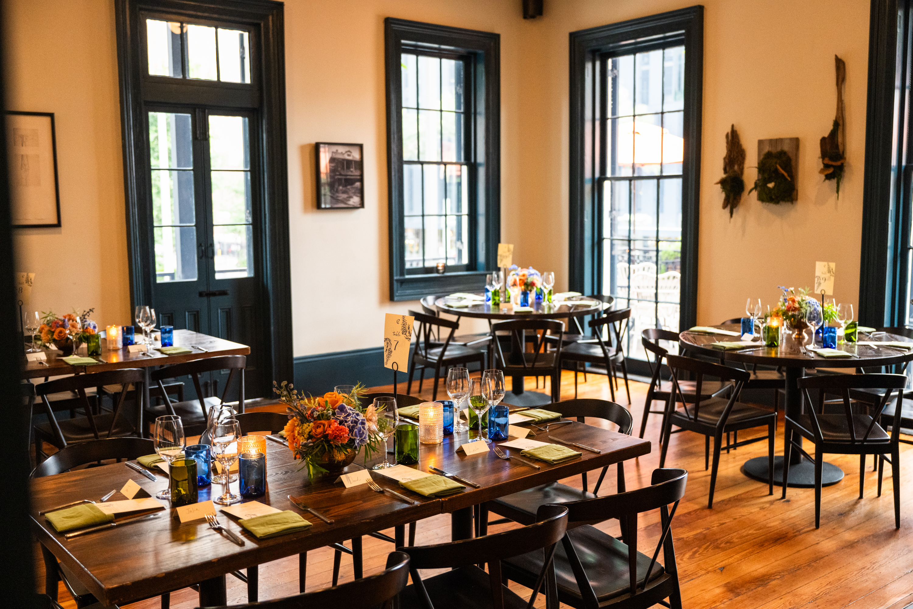 a dining room with several tables set for a meal