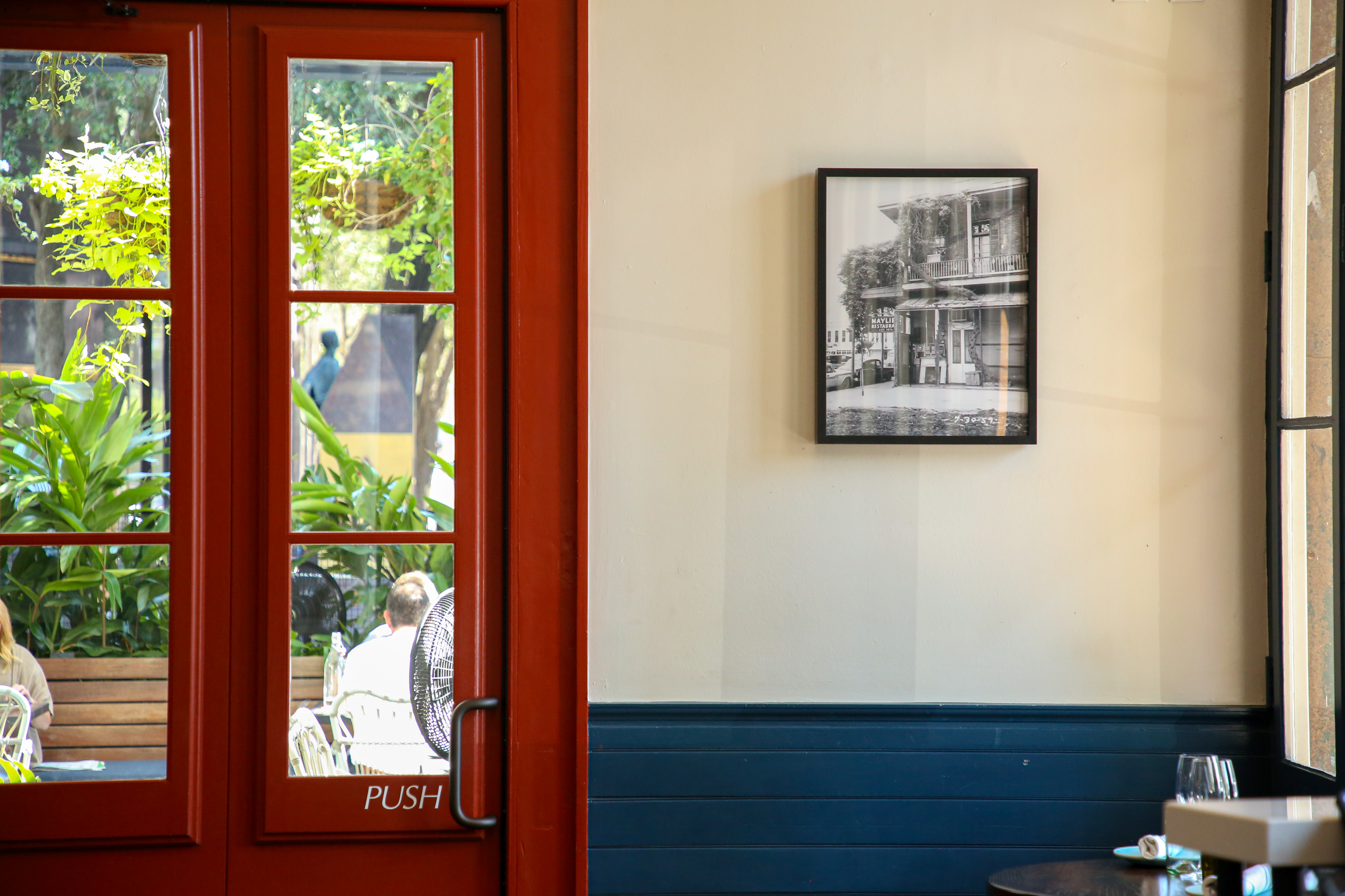 A vibrant red door framed in blue, featuring a small window above, inviting and colorful in appearance