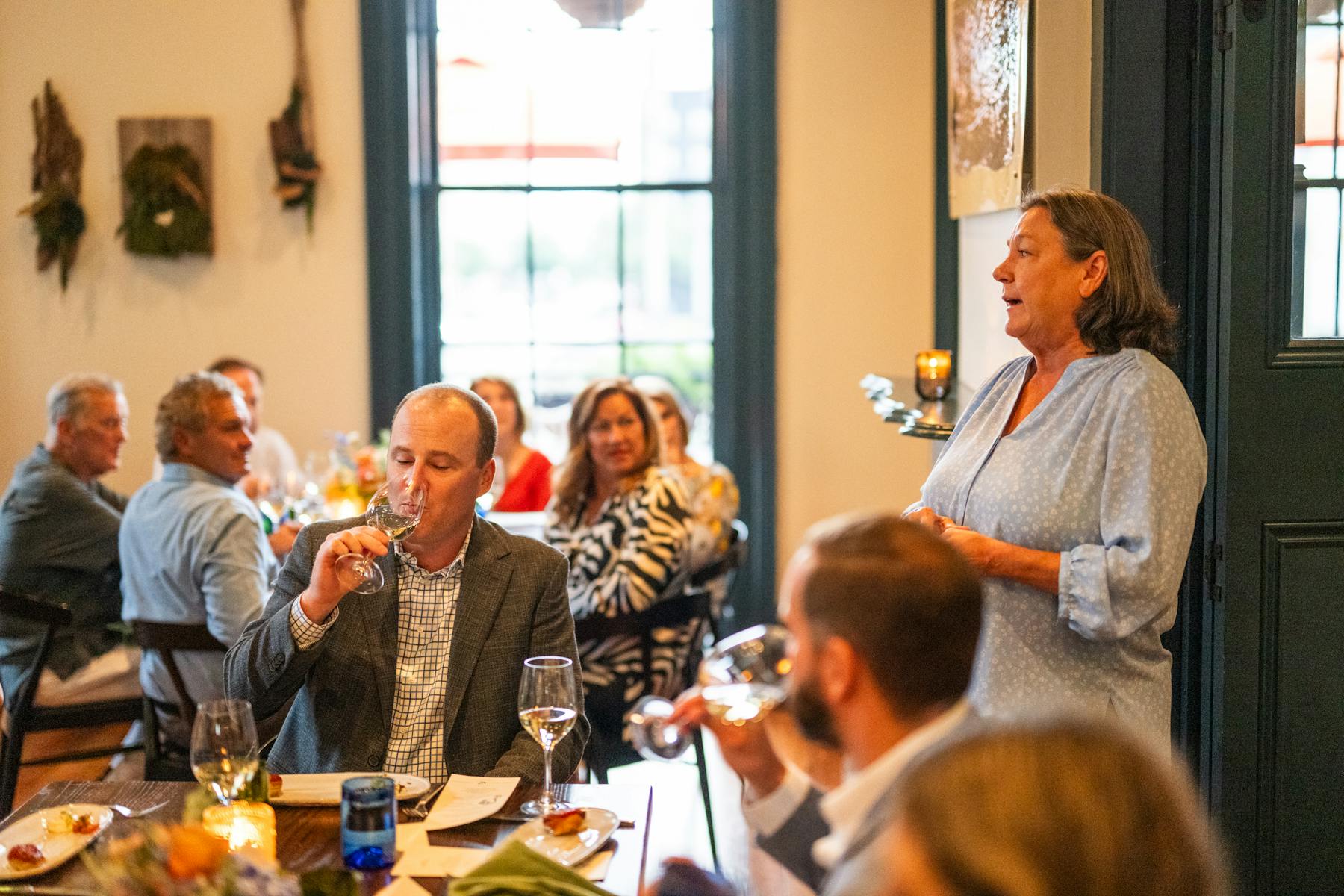 a group of people sitting at a table with wine glasses