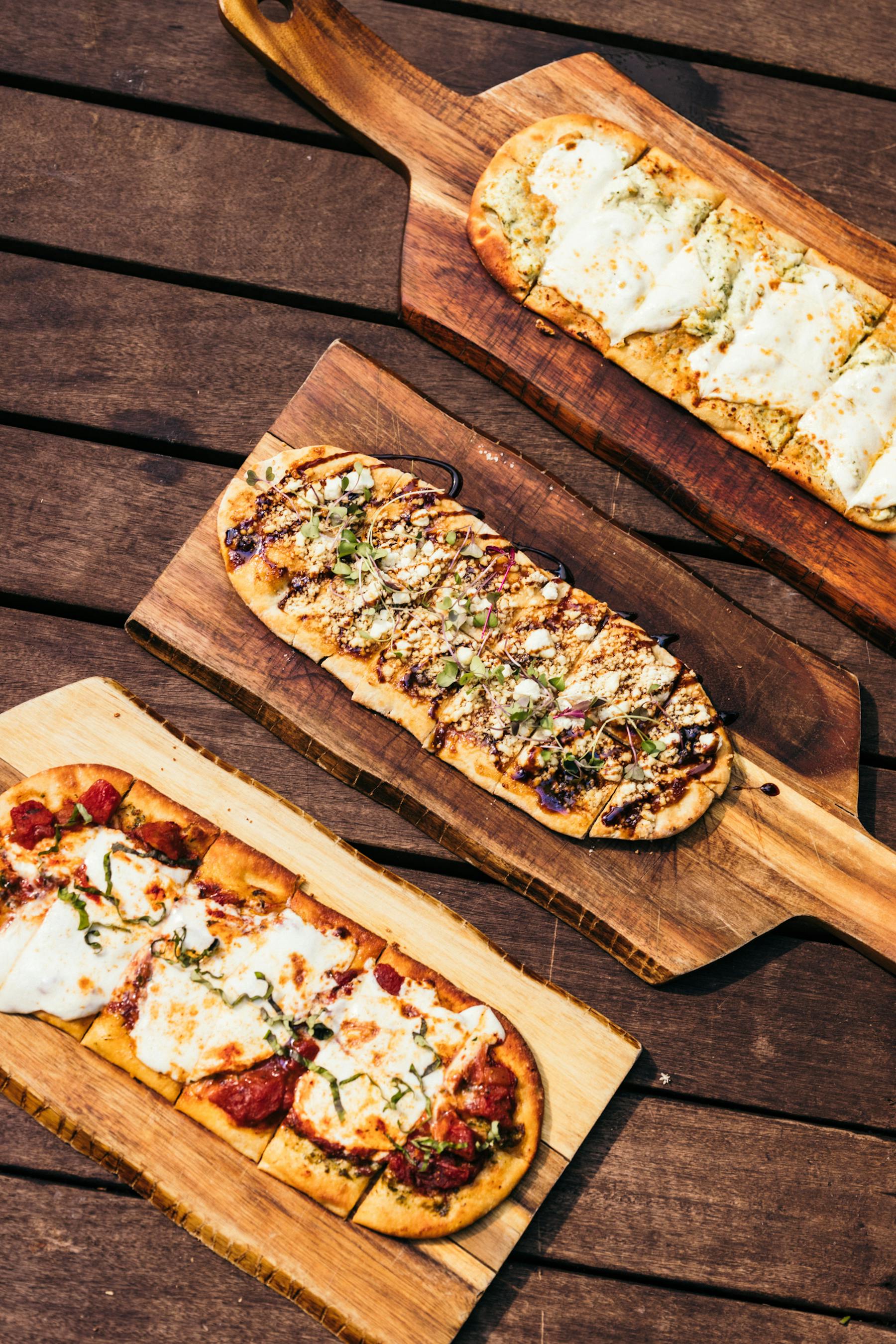 a slice of pizza sitting on top of a wooden cutting board