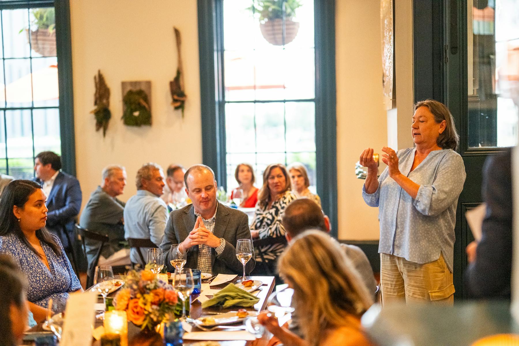 a group of people sitting at a table full of food