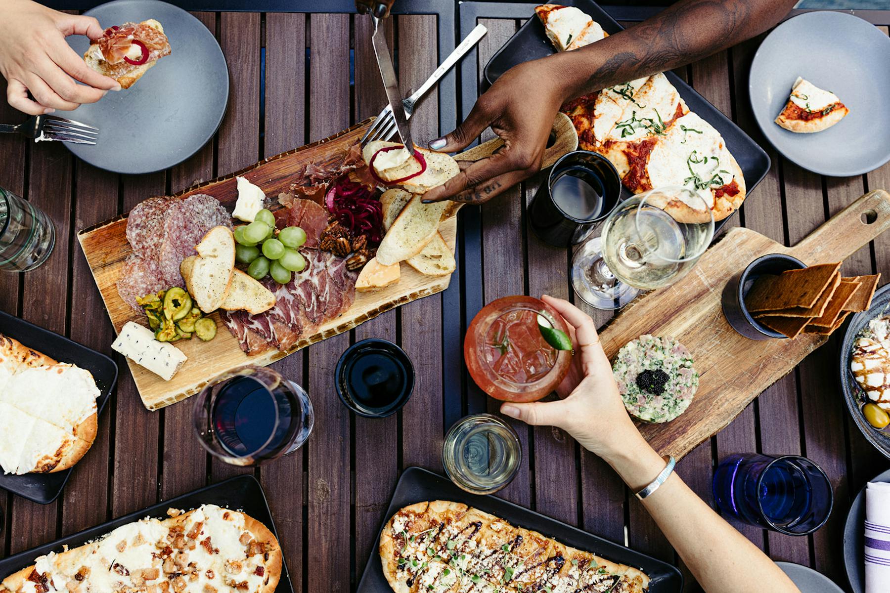 a group of people sitting at a table with a plate of food