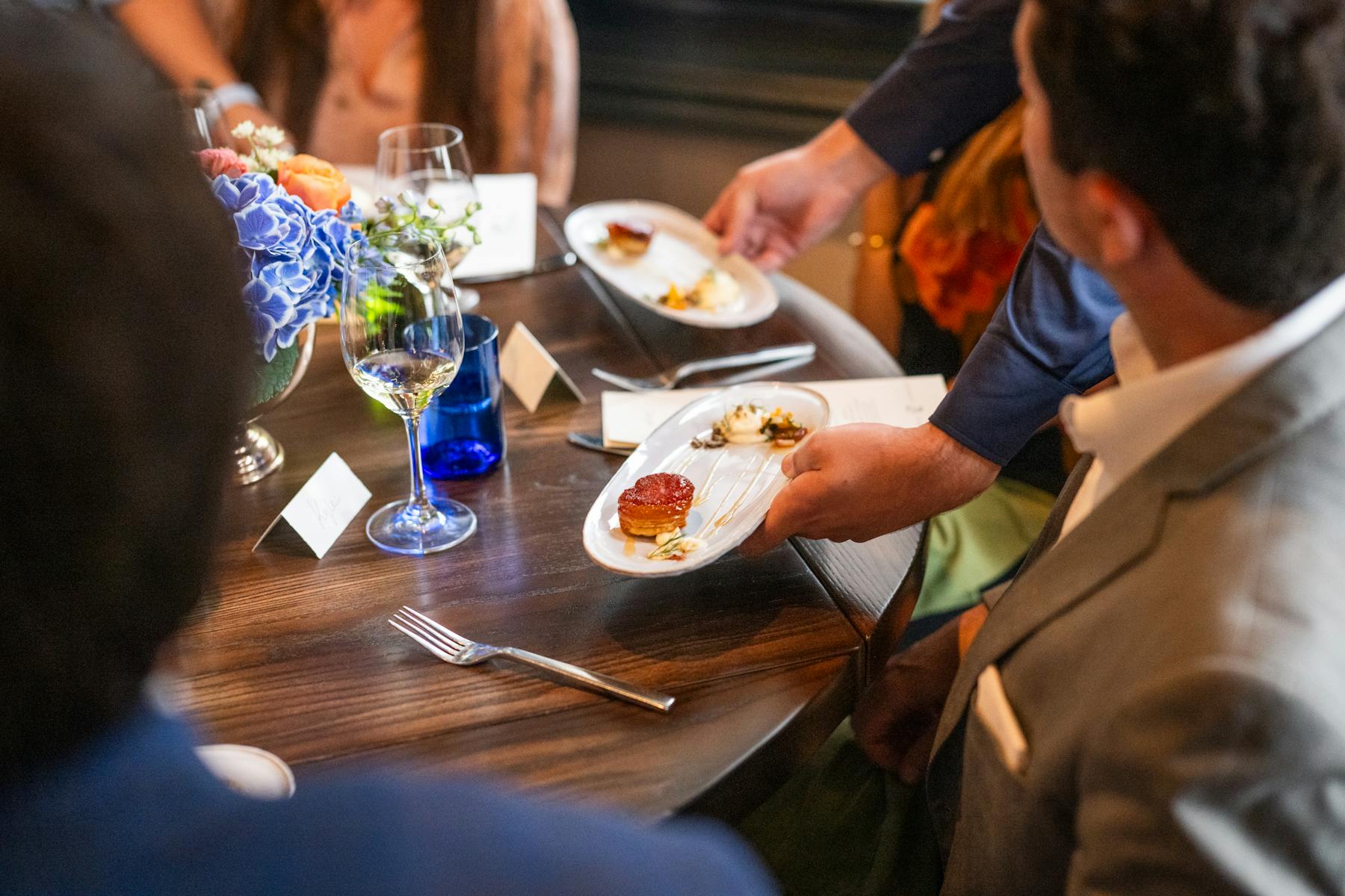 a group of people sitting at a table eating food