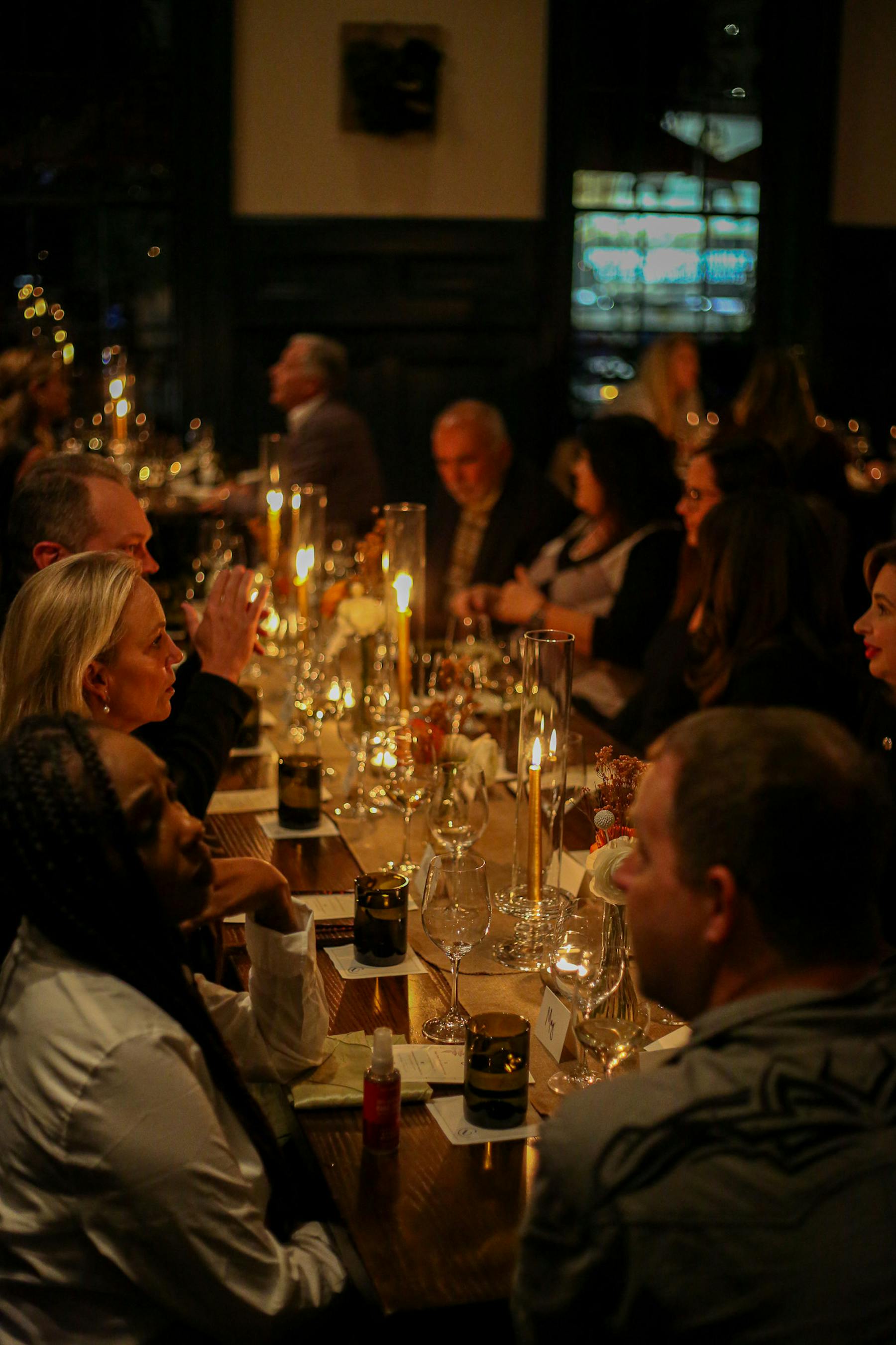 a group of people sitting at a table with wine glasses