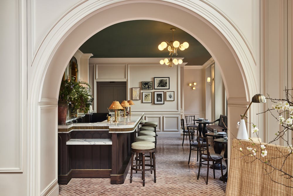 a living room filled with furniture and vase of flowers on a table