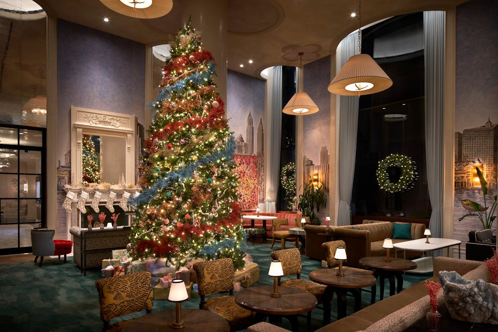 a living room filled with furniture and vase of flowers on a table