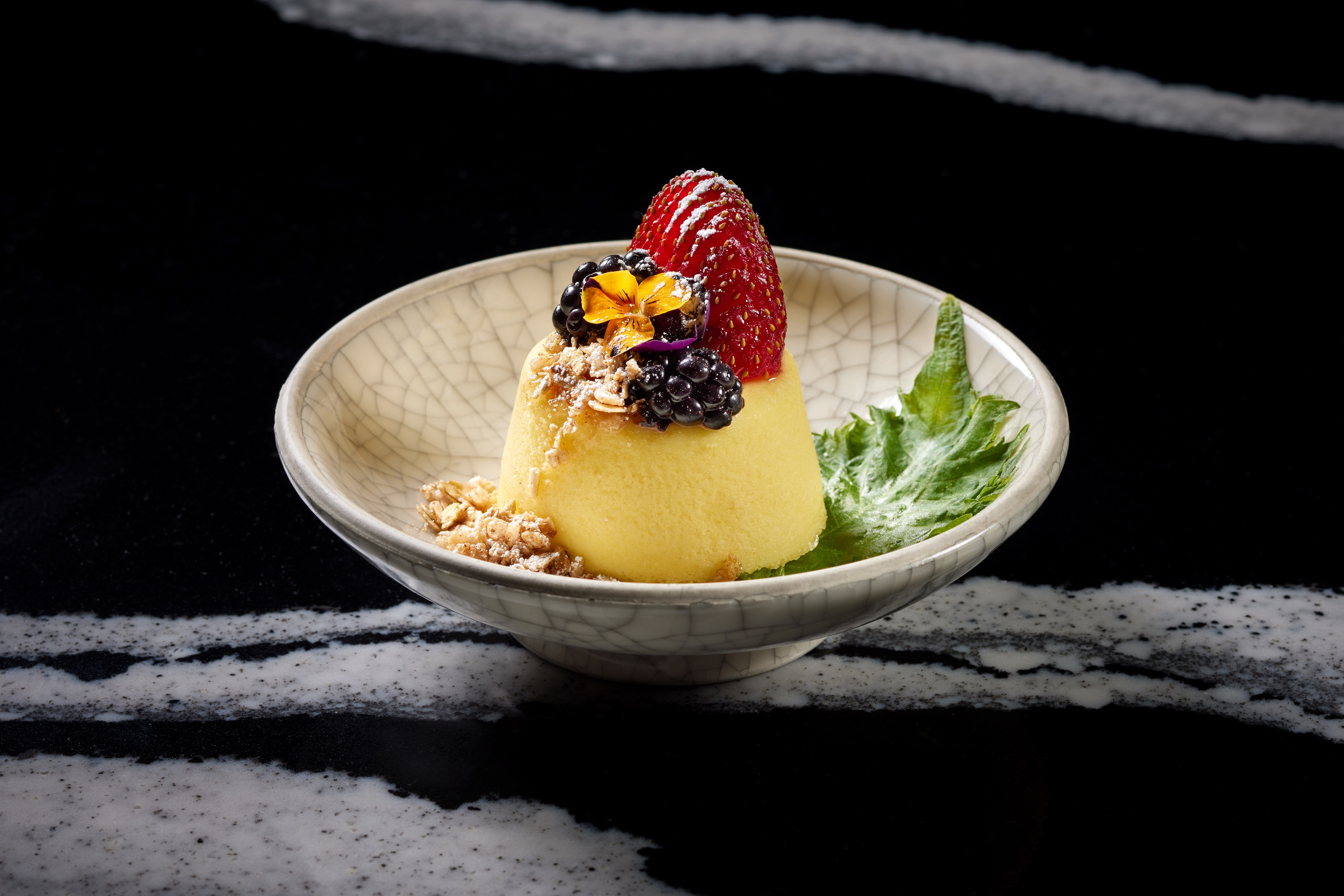 a bowl of fruit sitting on a table
