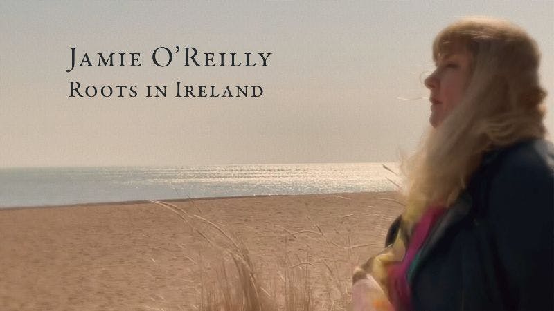 a woman standing in front of a beach