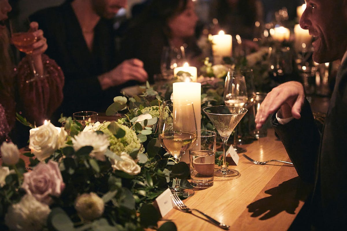 a group of people sitting at a table with wine glasses