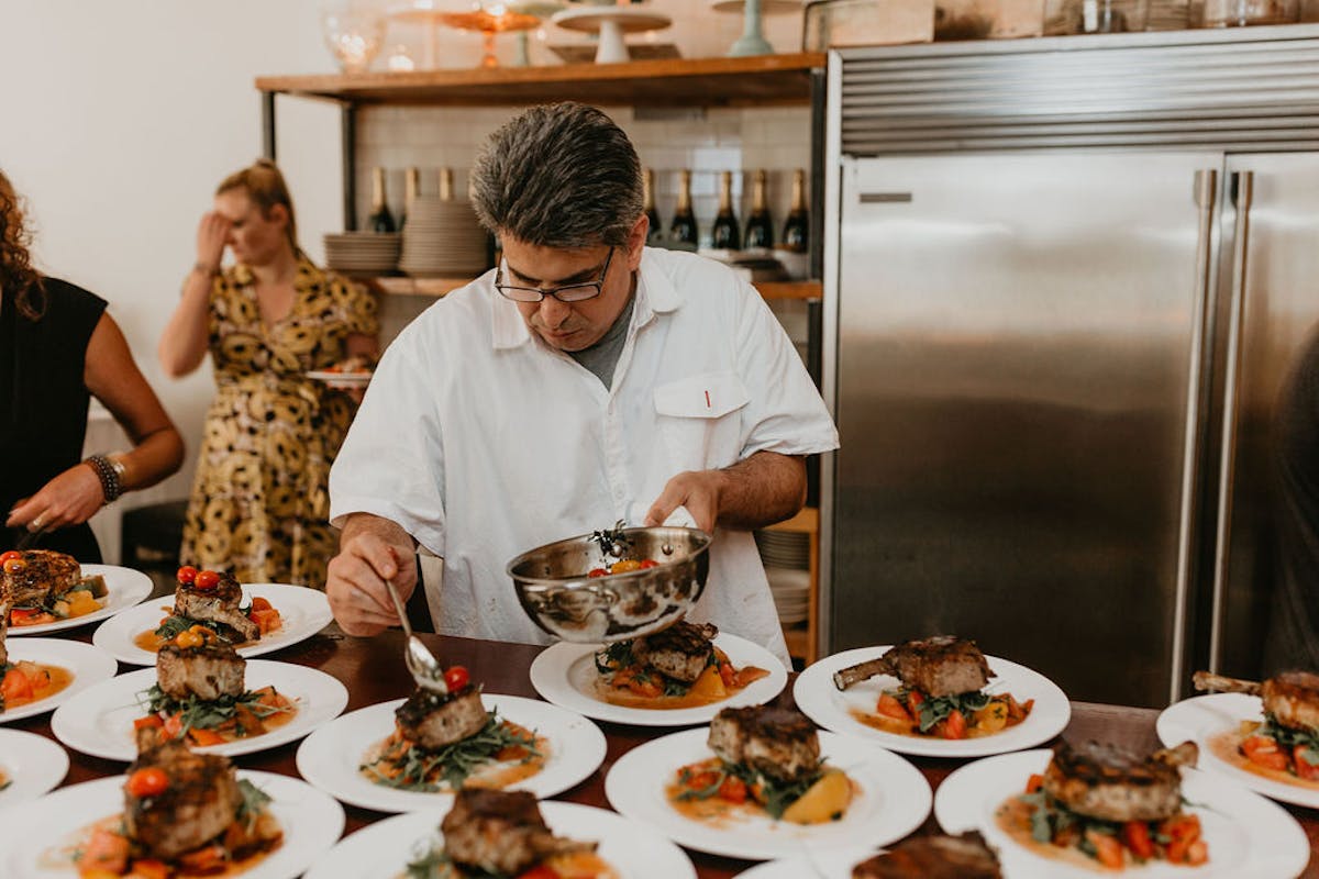 a group of people sitting at a table with a plate of food