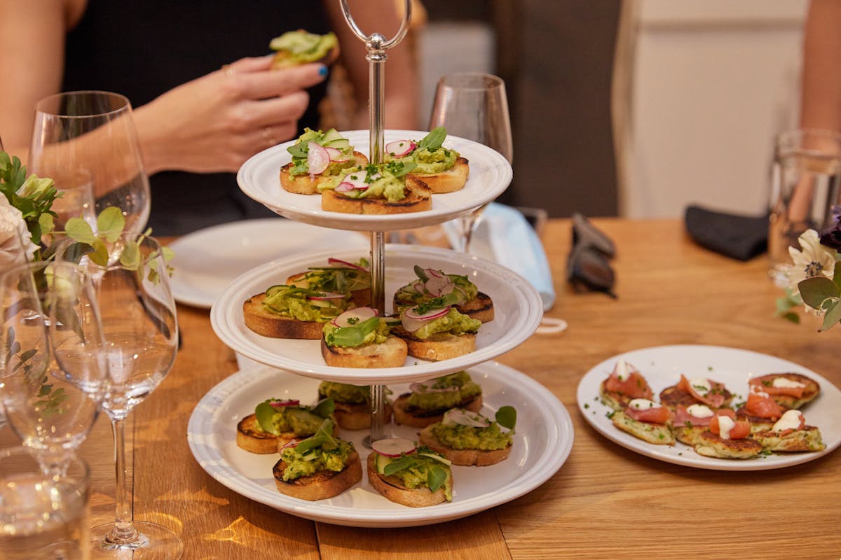 a woman sitting at a table with a plate of food