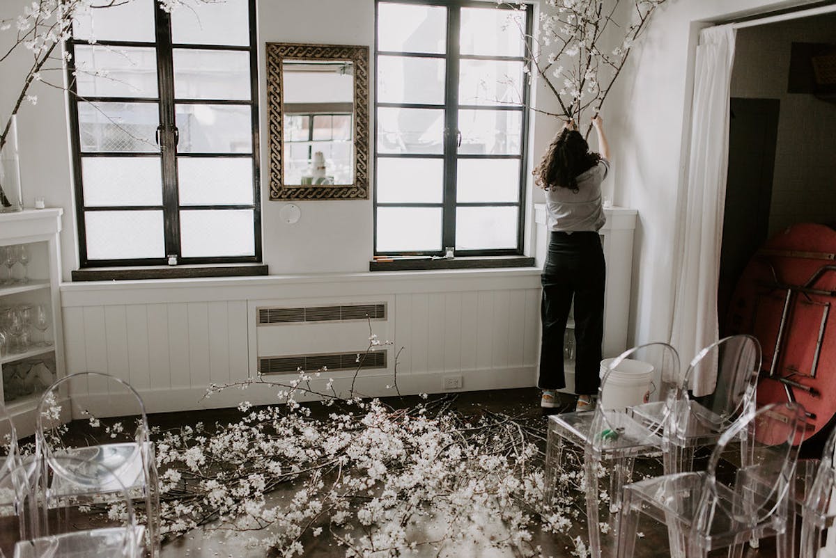 a vase with flowers in front of a window