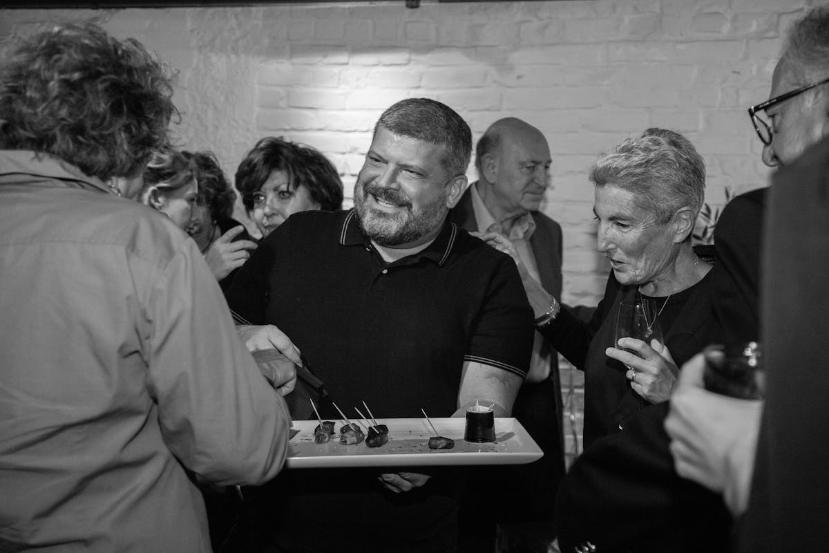 a group of people holding wine glasses