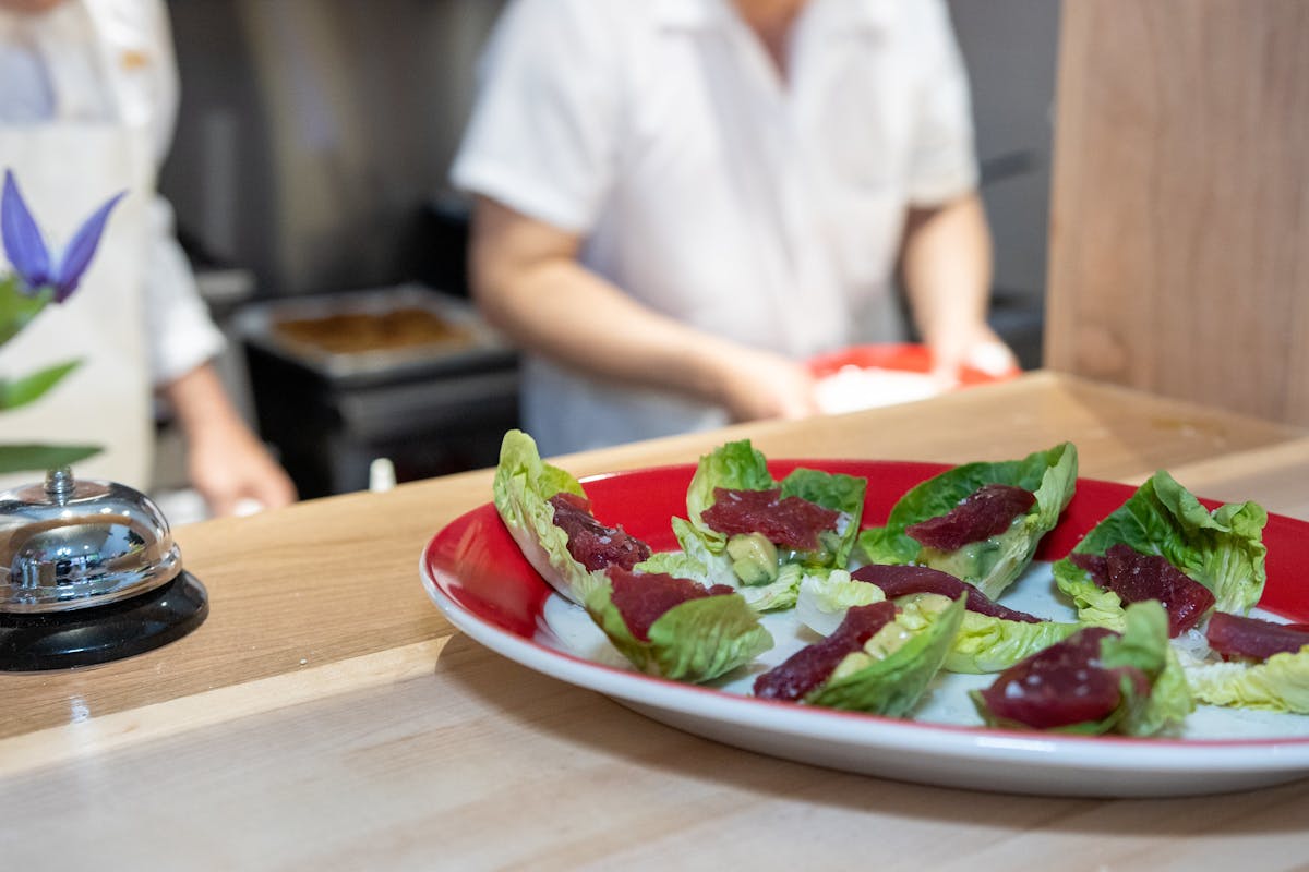 a person sitting at a table with a plate of food
