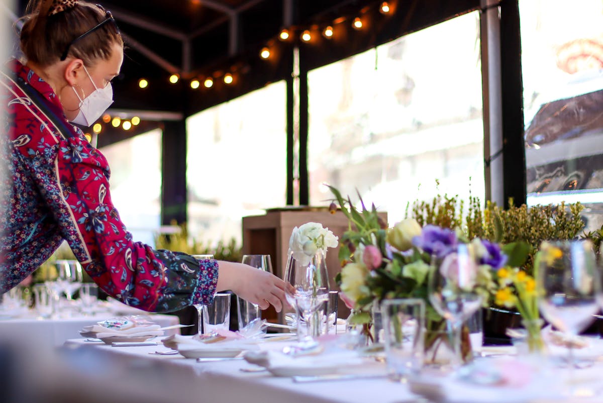 a person sitting at a table with a cake