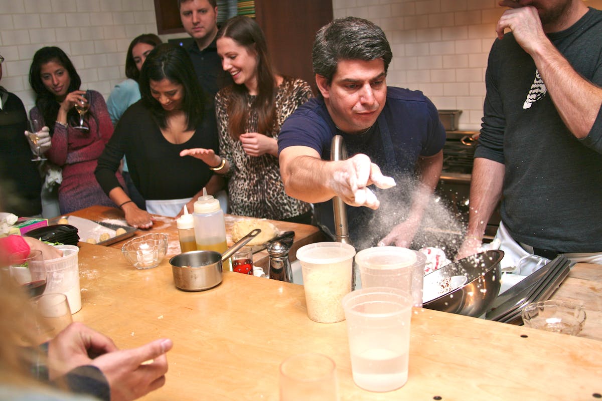 a group of people sitting at a table eating food