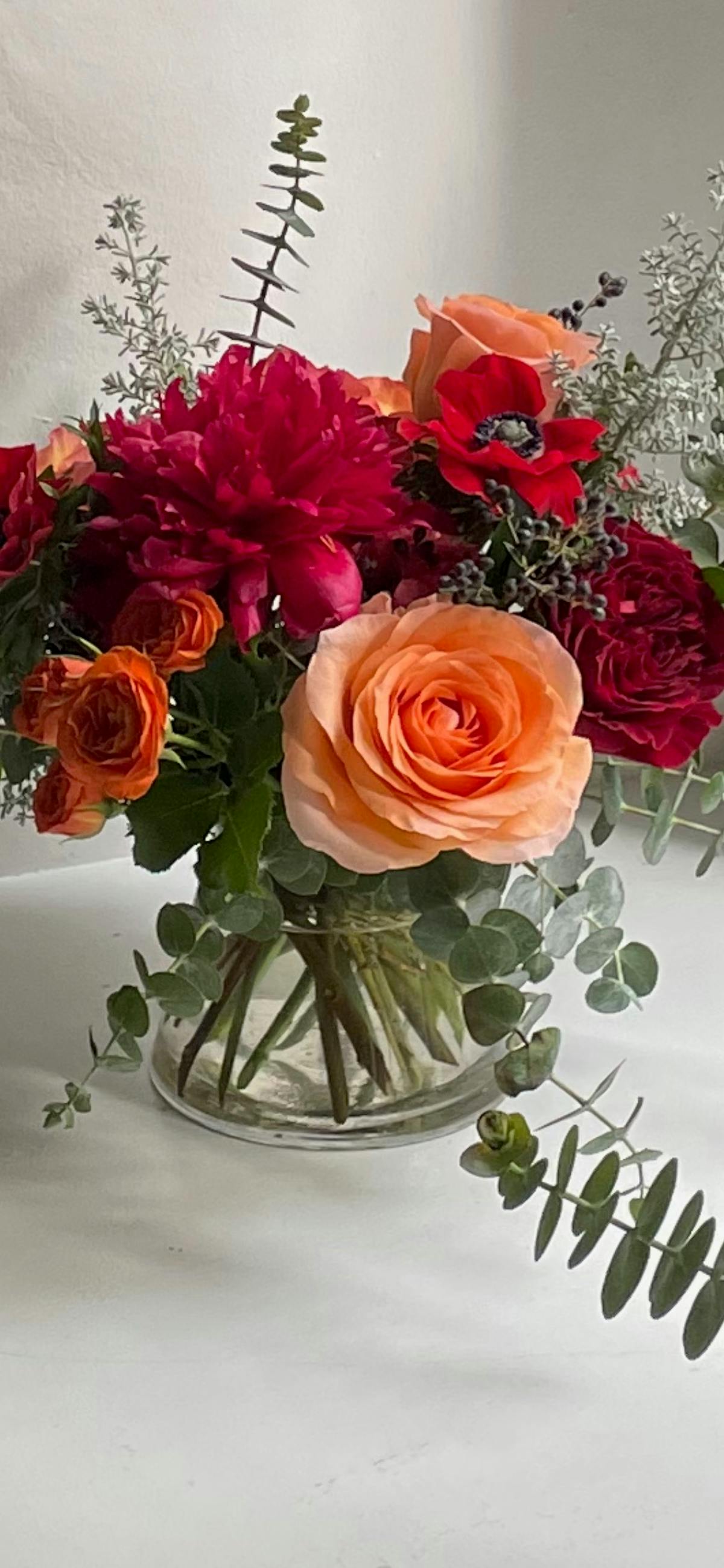 a bouquet of flowers in a vase on a table