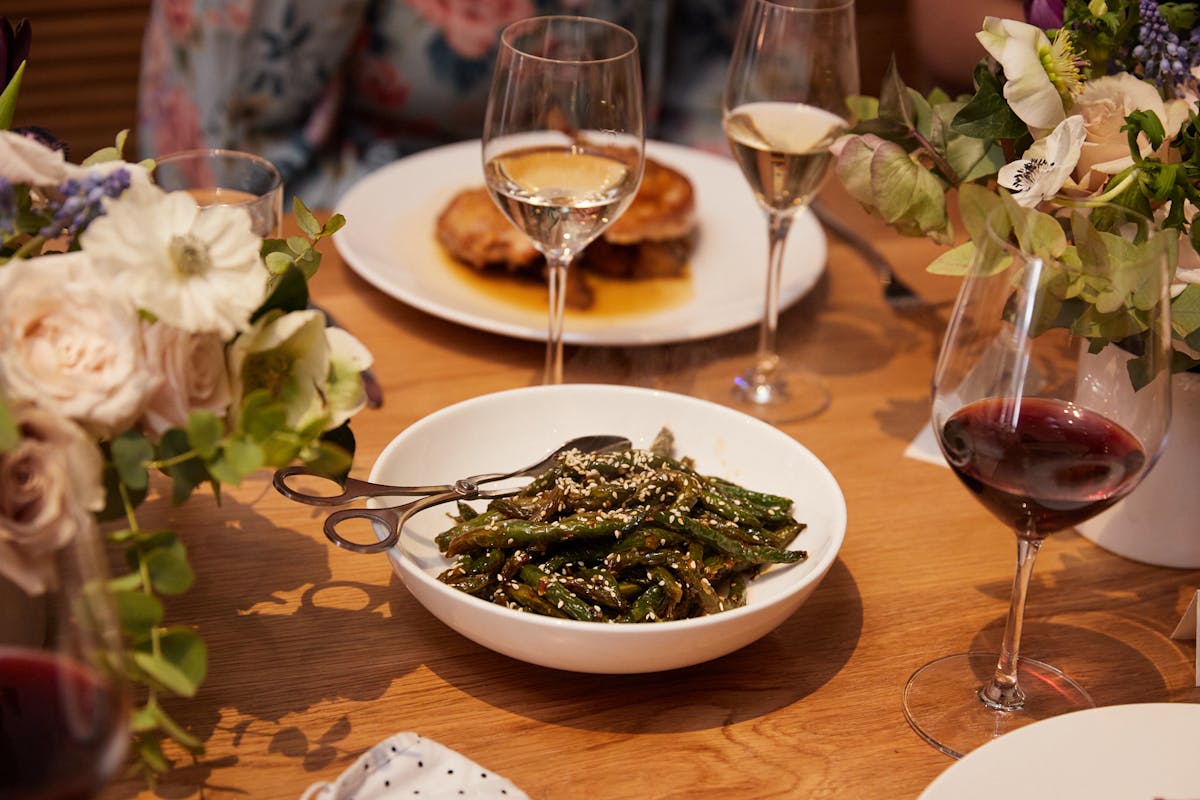 a plate of food and glasses of wine on a table