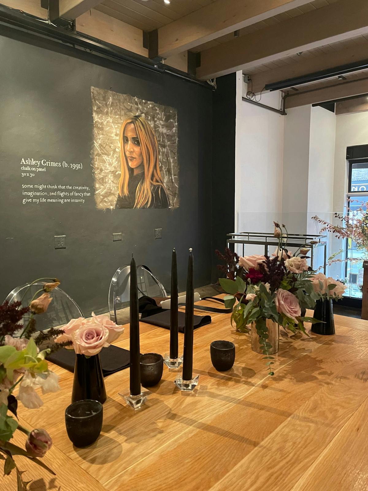 a room filled with furniture and vase of flowers on a table