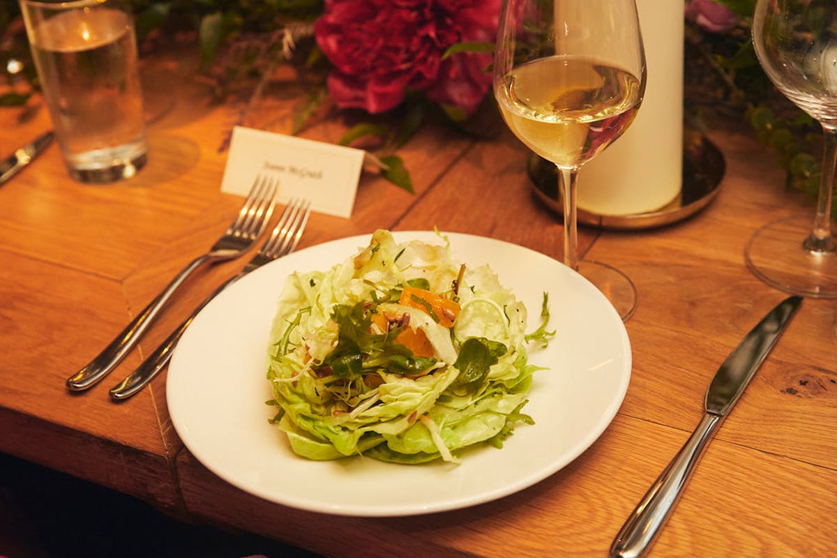 a plate of food and glasses of wine on a table