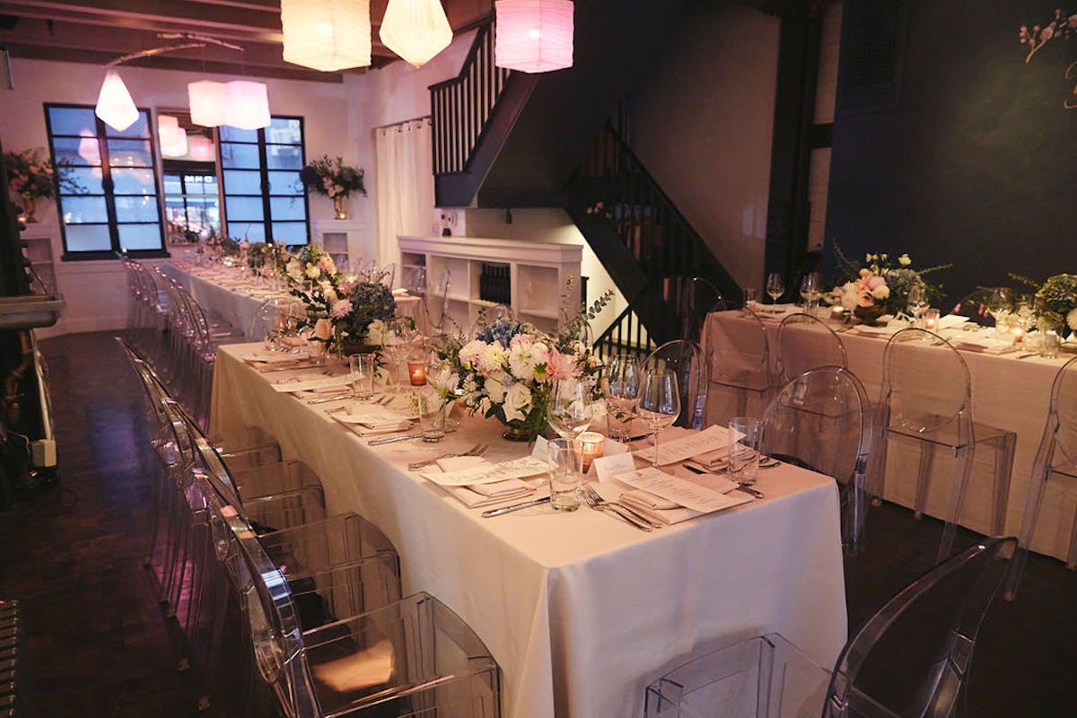 a room filled with furniture and vase of flowers on a table