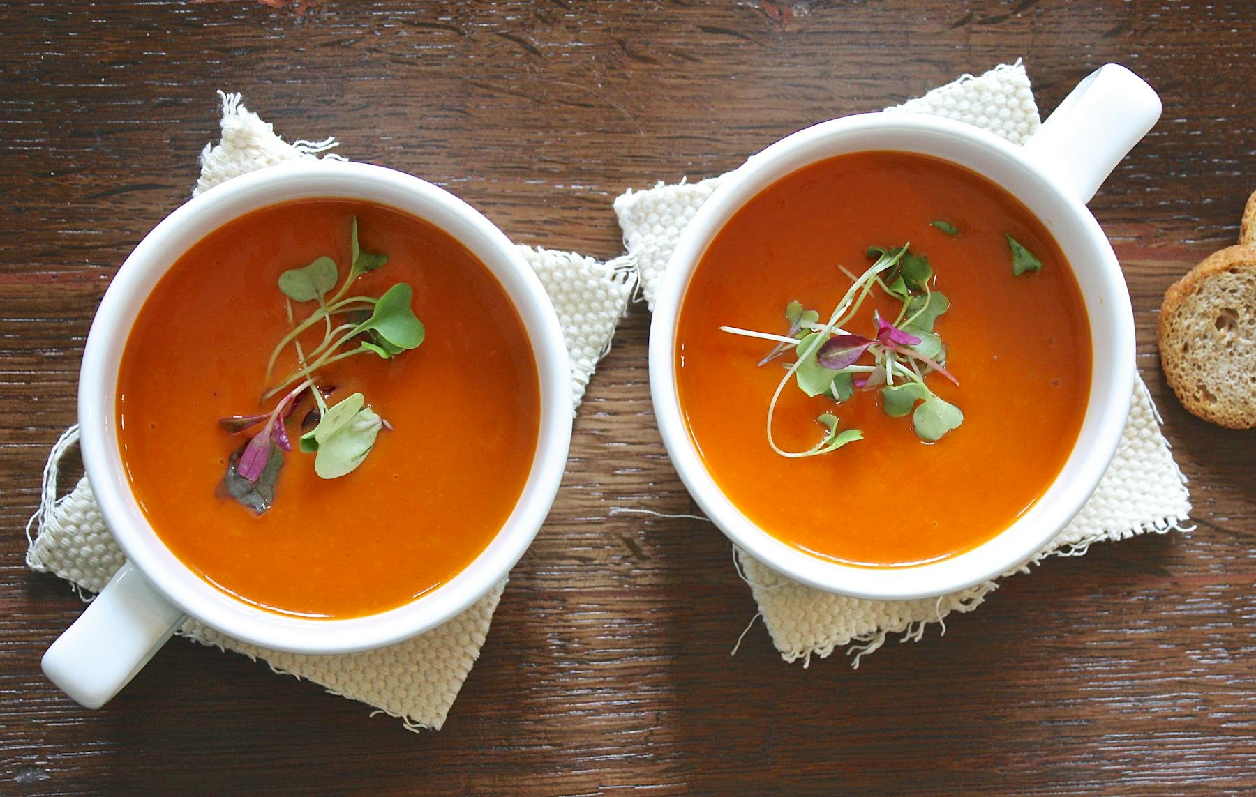 a bowl of soup sitting on top of a wooden table