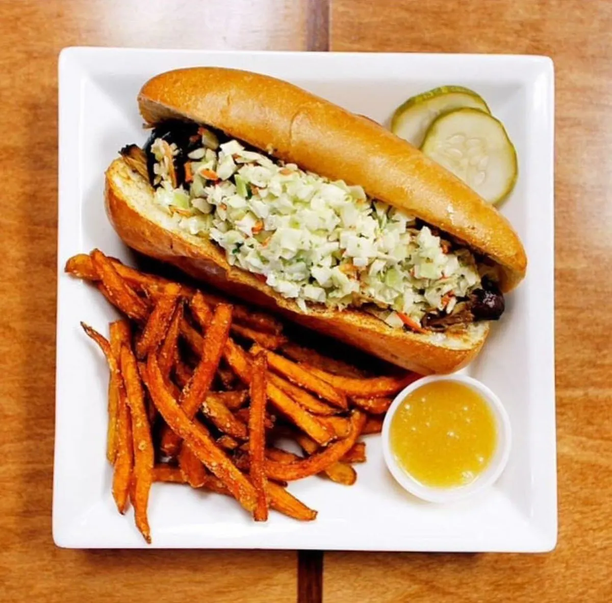 a plate of food with a sandwich and fries on a table