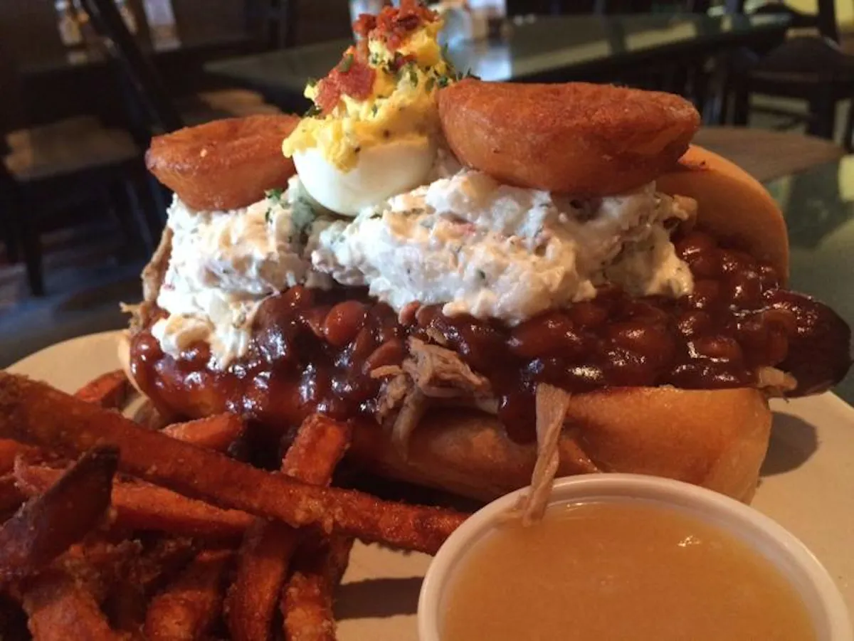 a close up of a sandwich and fries on a plate