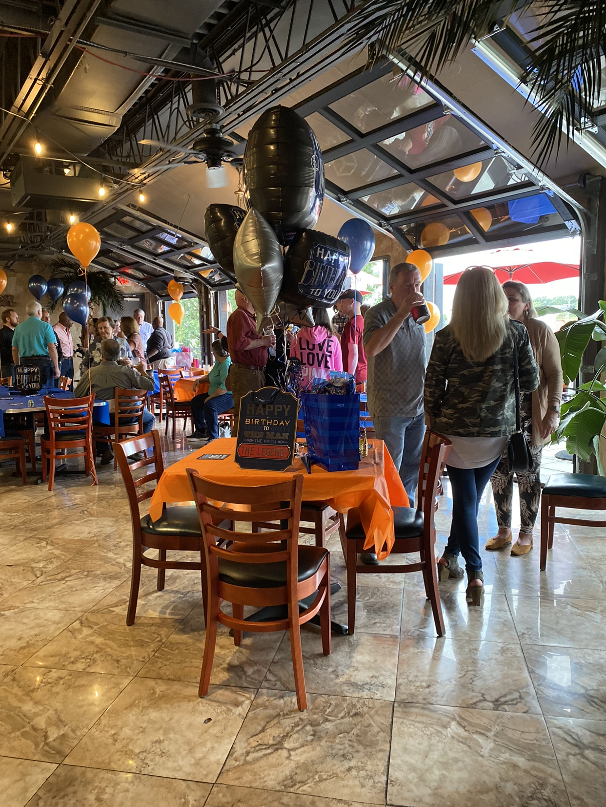 a group of people standing around a table