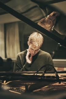 a person sitting at a piano