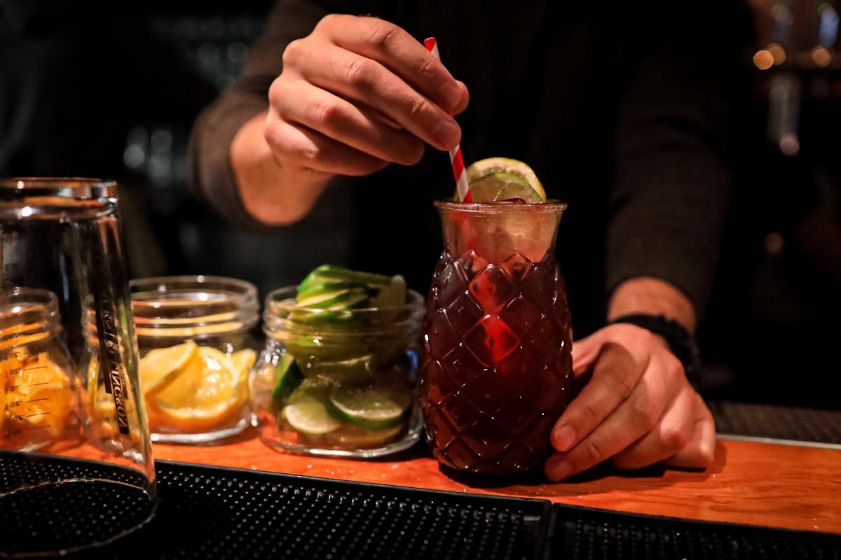 a person sitting at a table with food and drinks