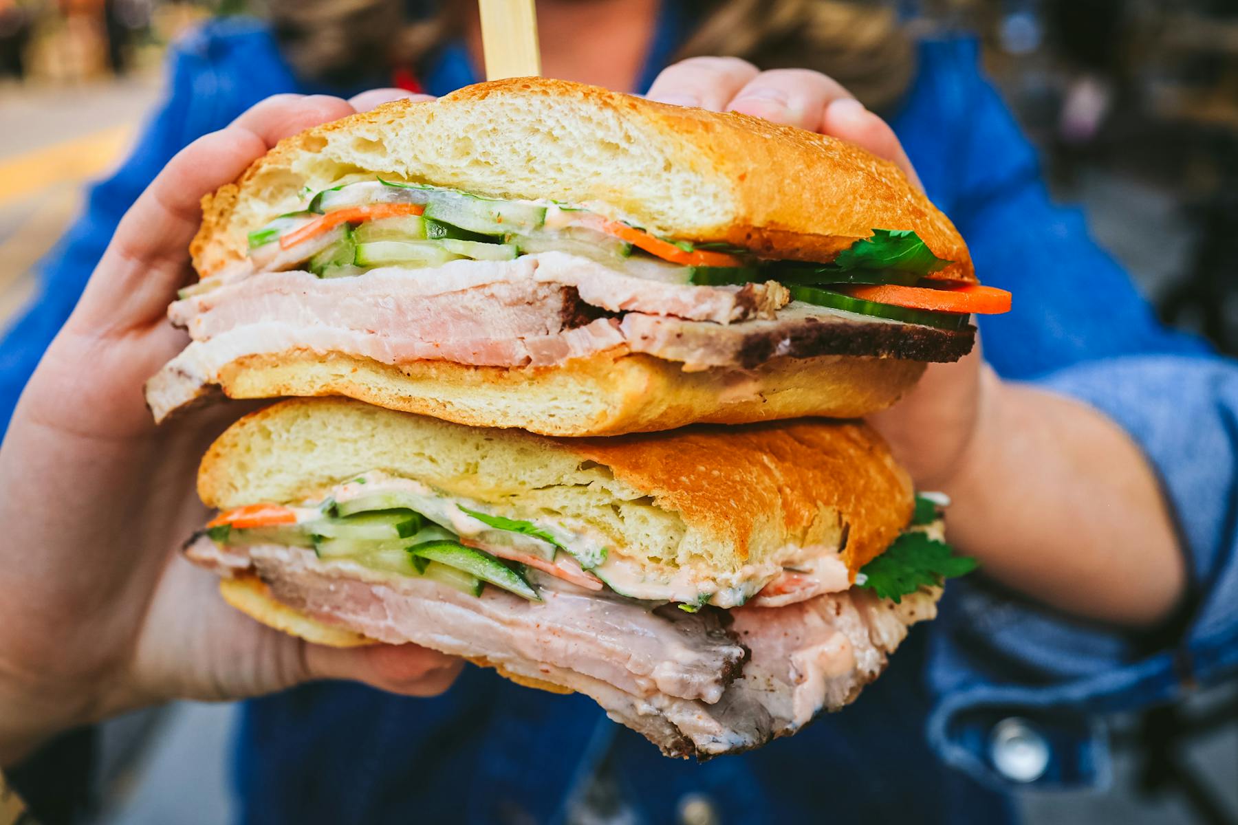 a close up of a person holding a sandwich