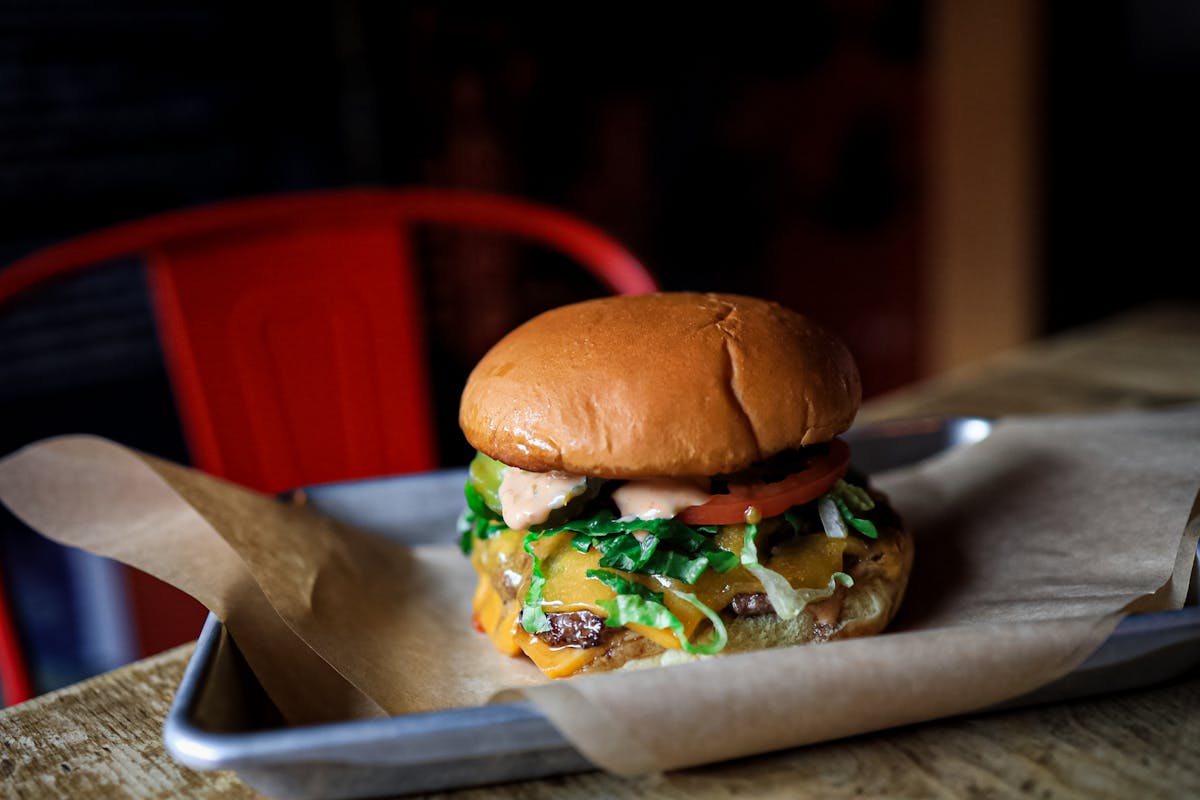 a close up of a sandwich sitting on top of a wooden table