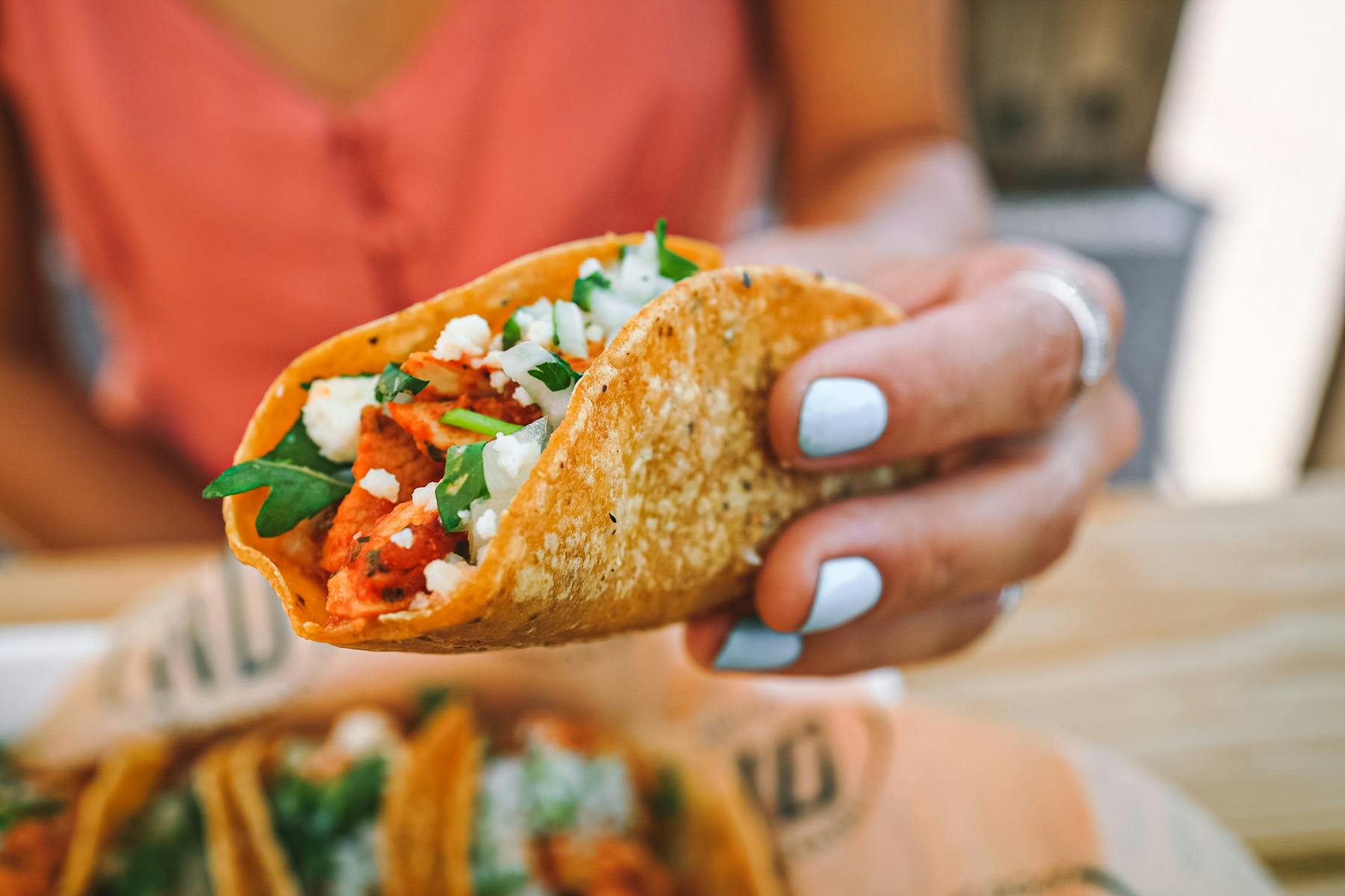 a close up of a person holding a sandwich in his hand