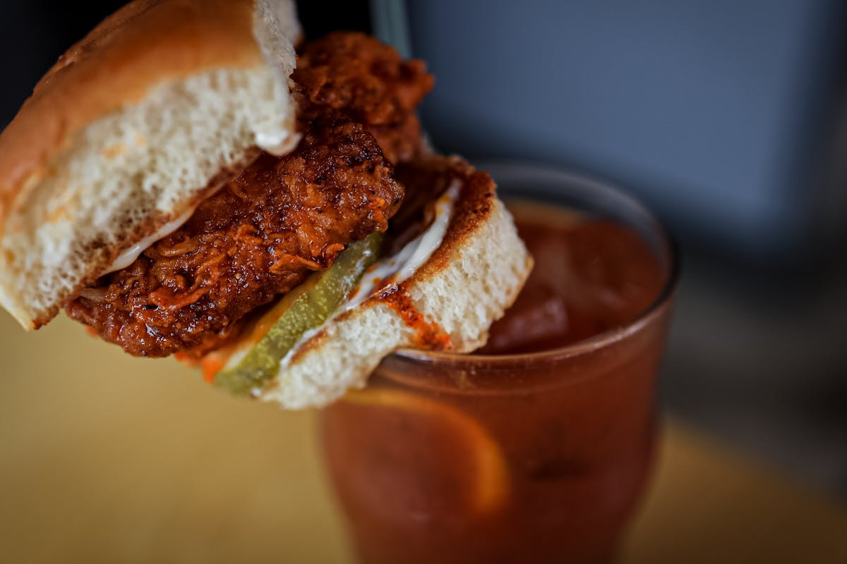 a close up of a sandwich and a cup of coffee
