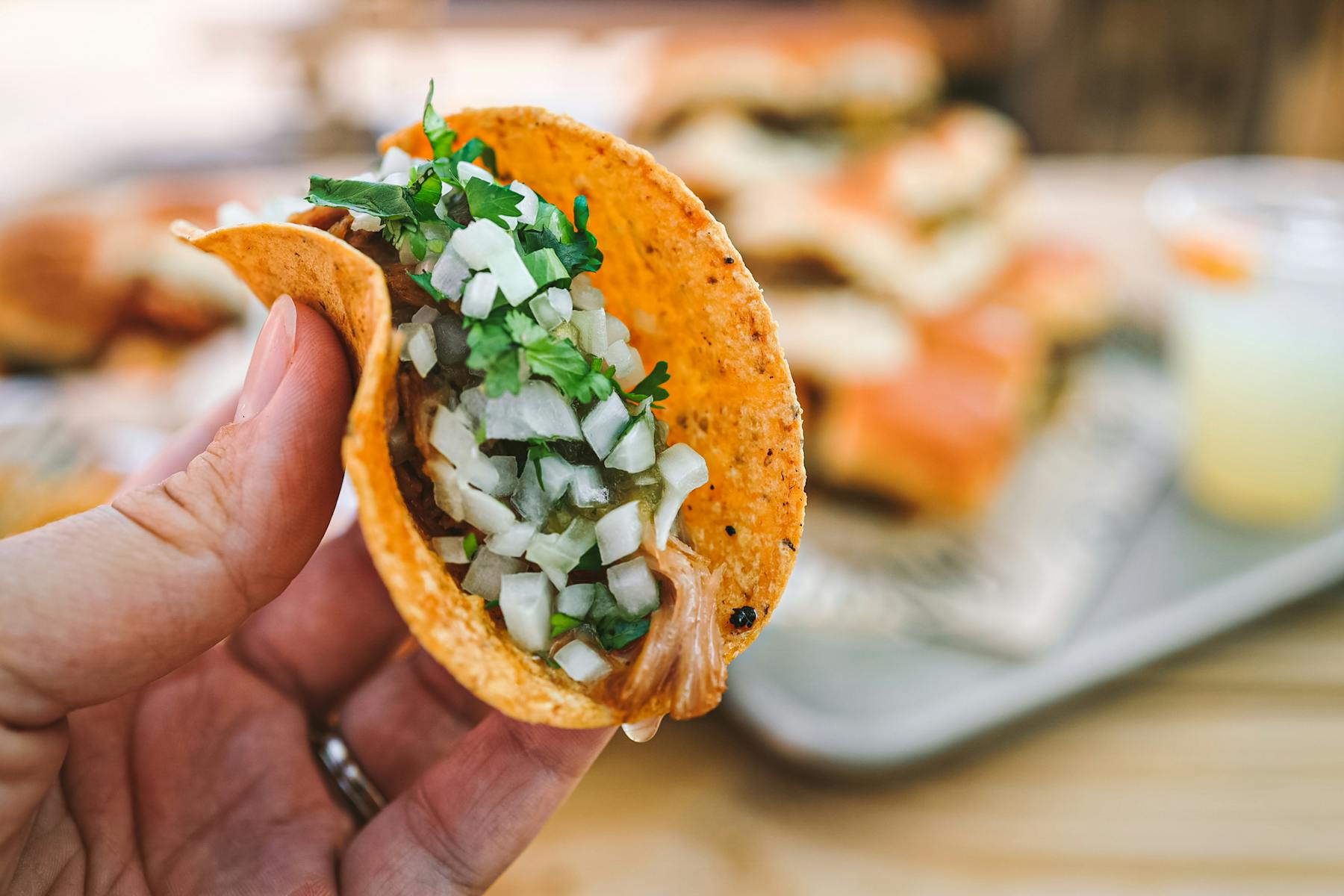 a close up of a hand holding a piece of food