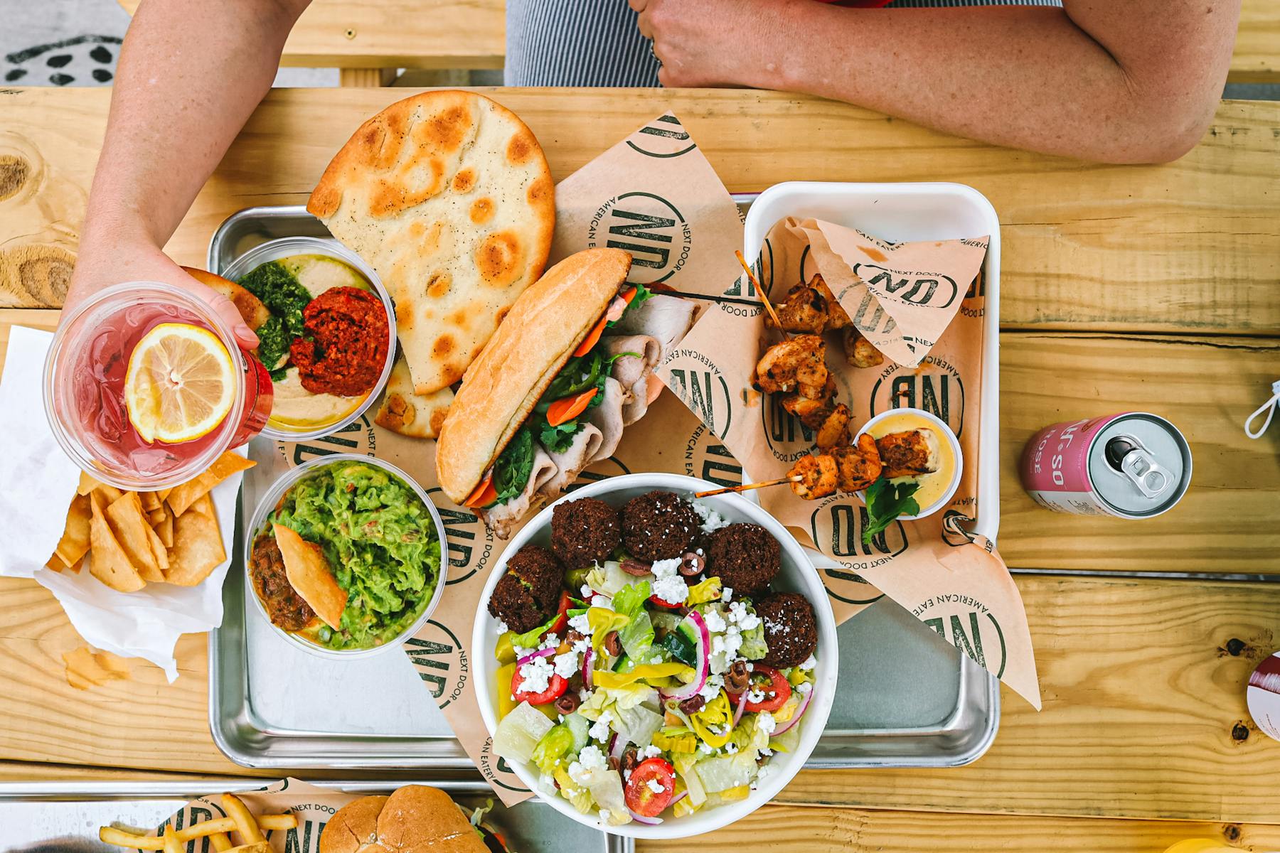 a person sitting at a table with a plate of food