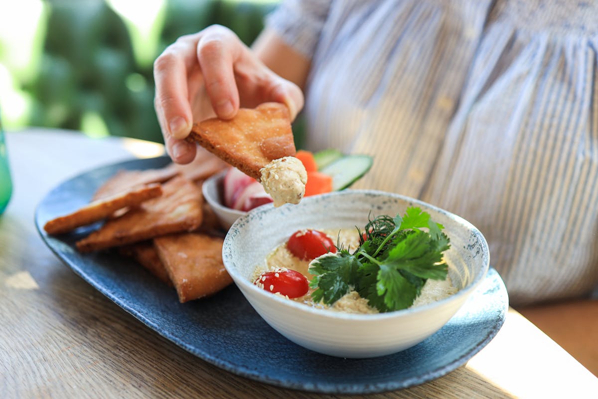 a person sitting at a table with a plate of food