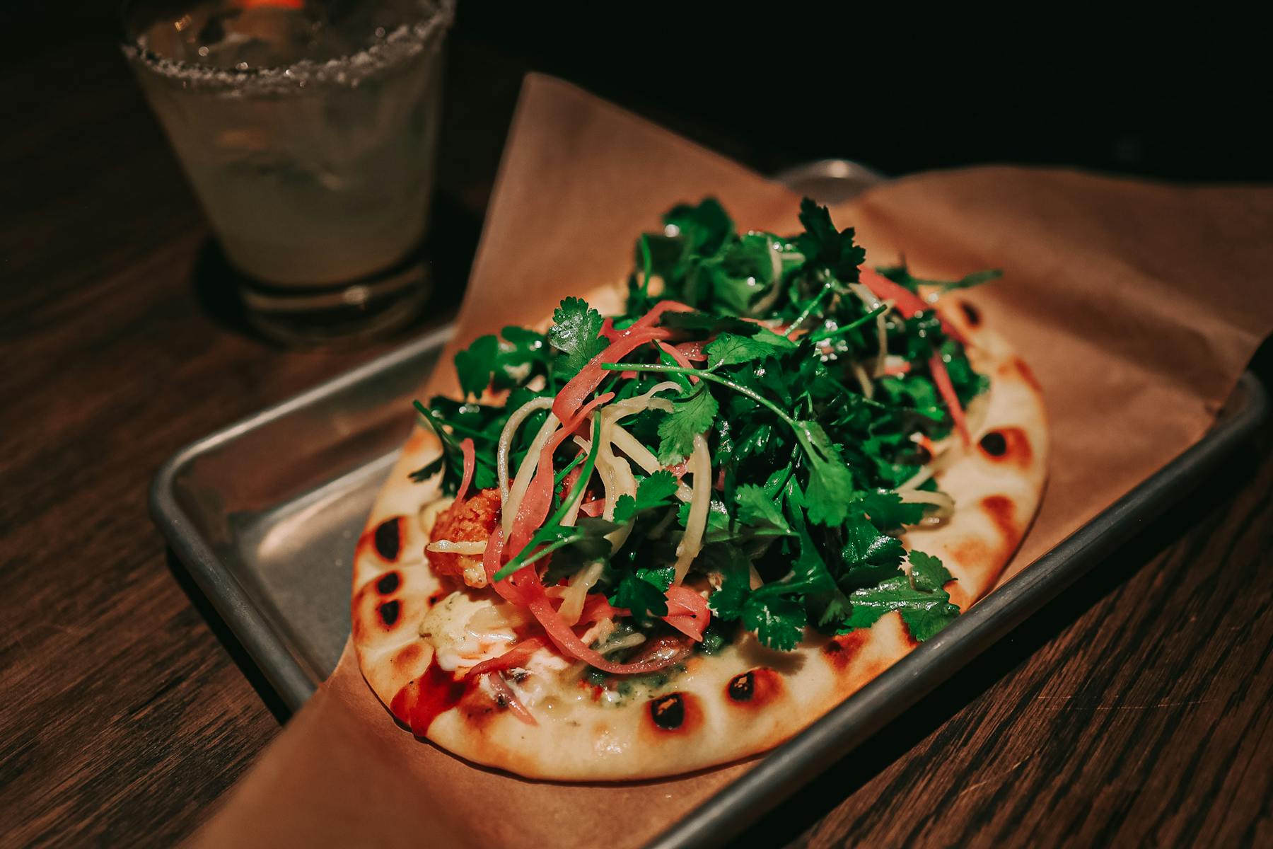 a pizza sitting on top of a wooden table