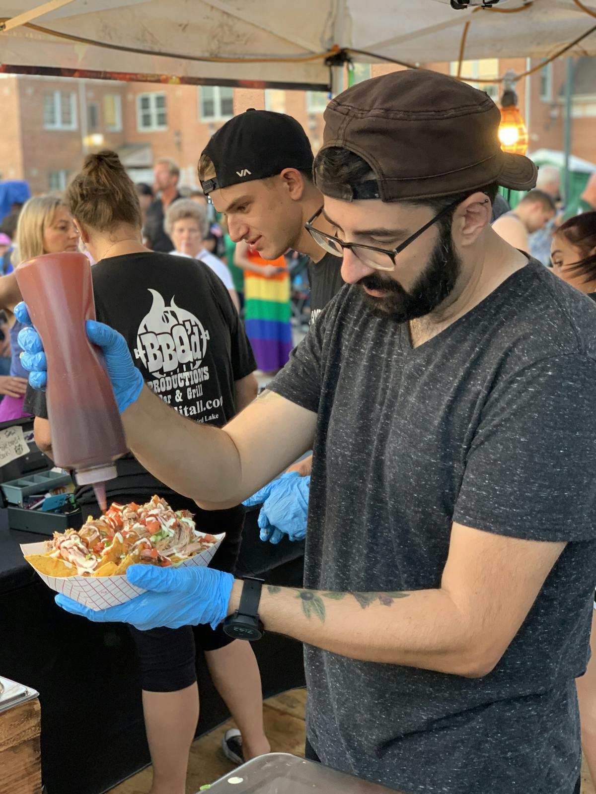 a group of people standing around a table eating food