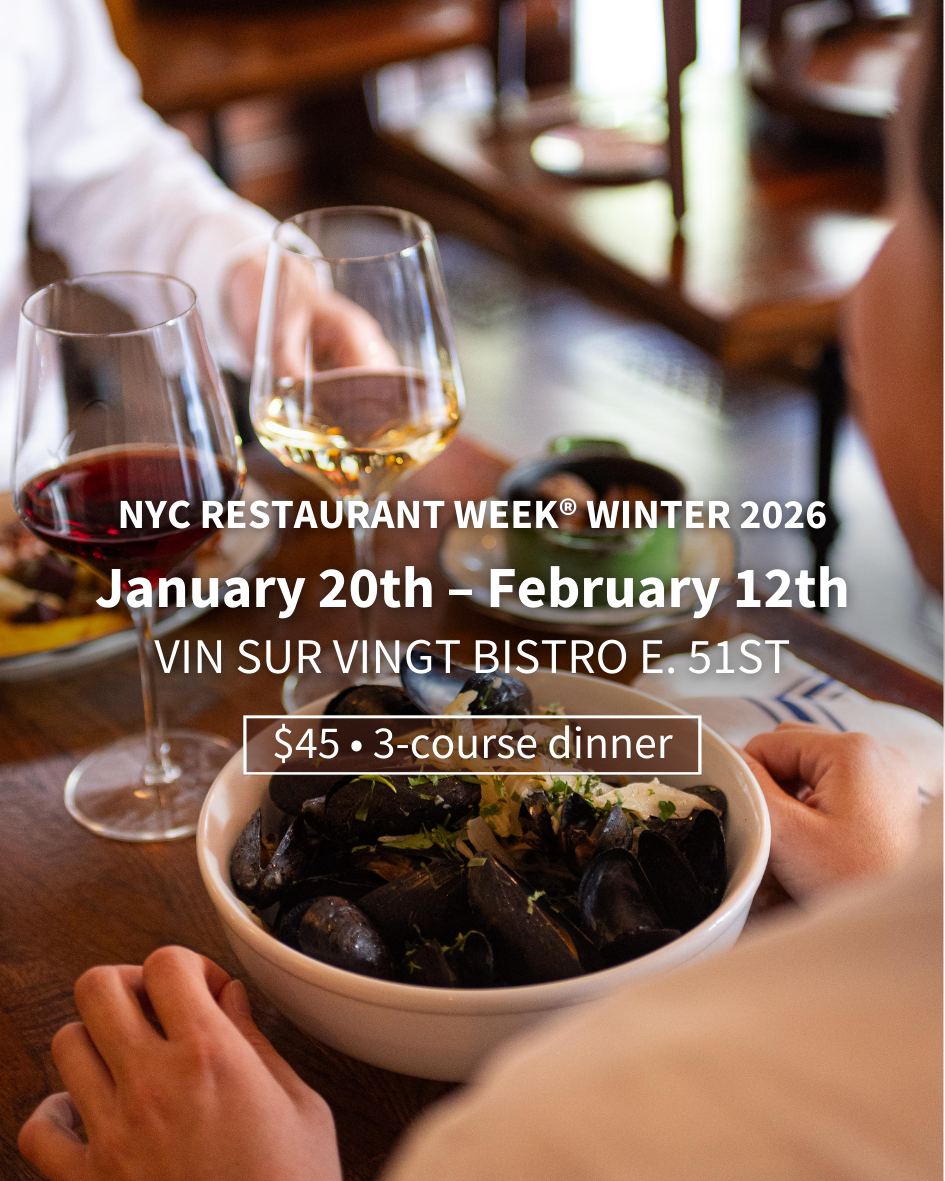 a person sitting at a table with wine glasses
