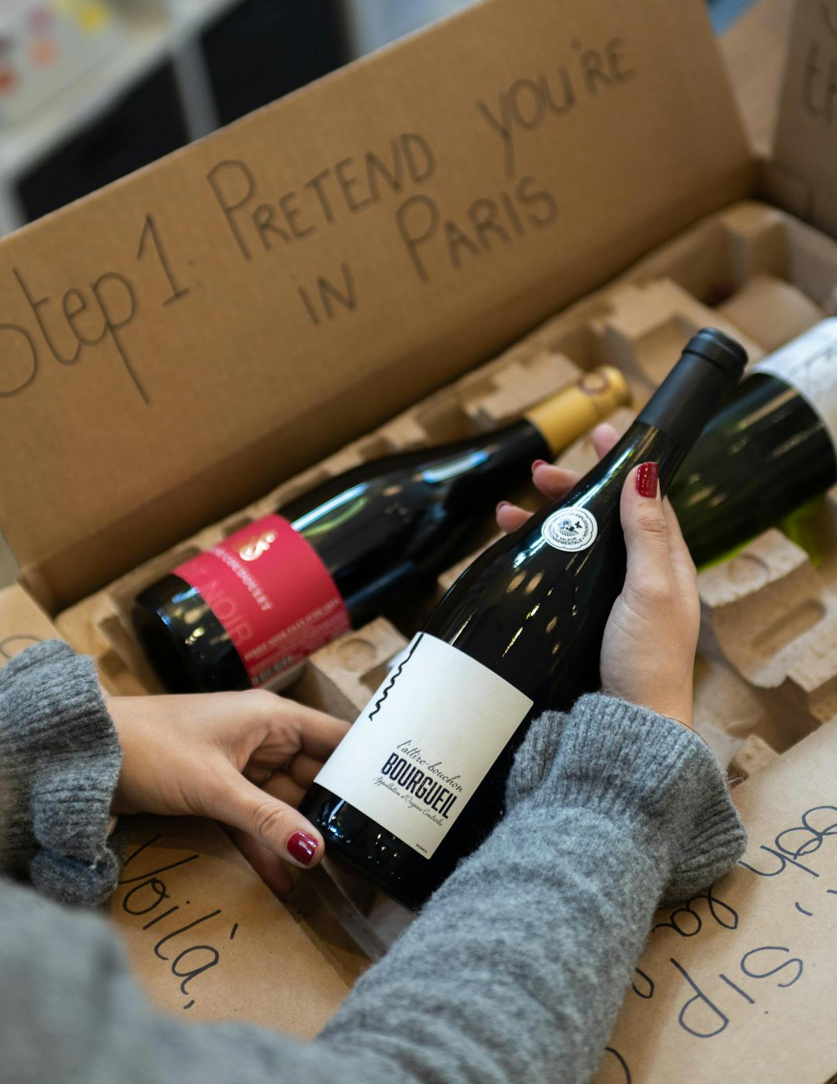 a hand holding a bottle